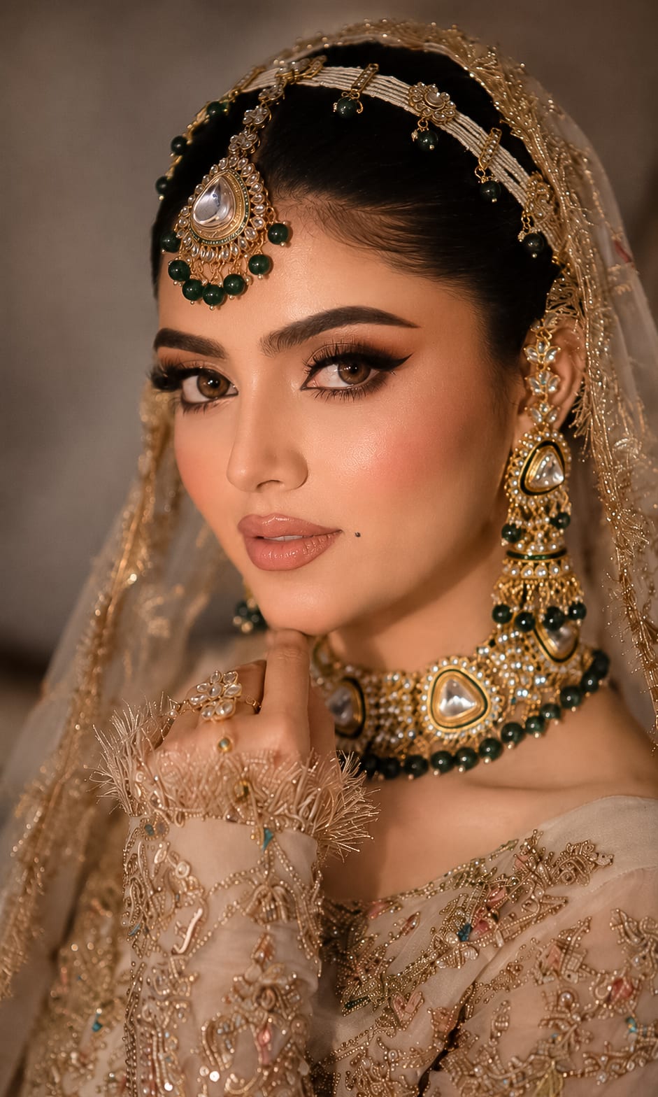 Close bridal portrait with green and gold jewelry