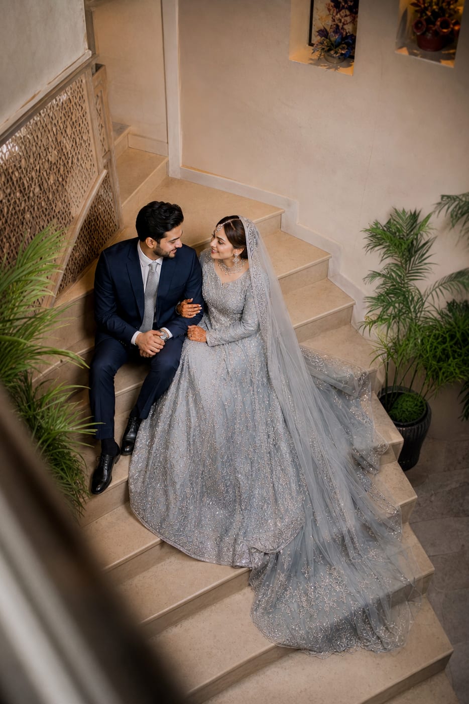 Couple seated together on an indoor staircase