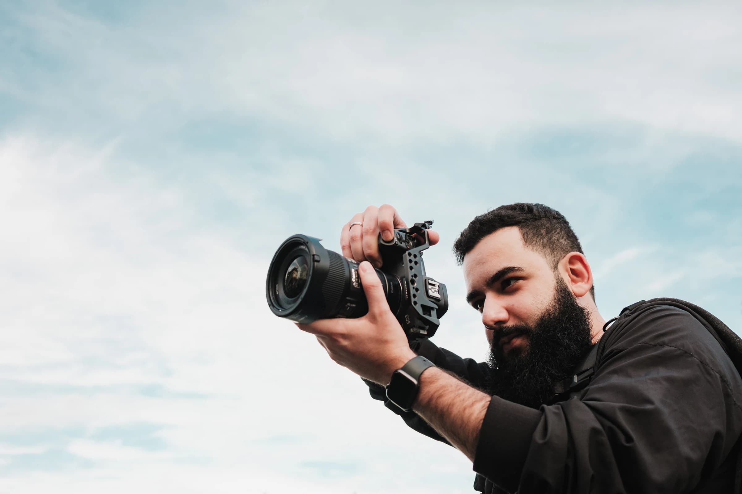Photographer composing a shot with a professional camera